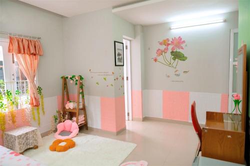 a childs room with pink and white walls at Lucky Home in Nha Trang