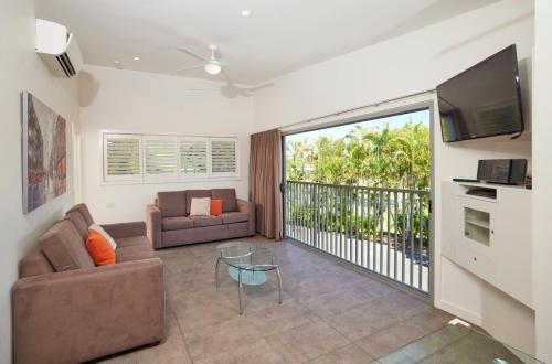 a living room with a couch and a television at Brisbane Holiday Village in Brisbane