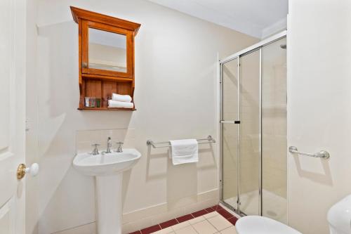 a bathroom with a sink and a shower at Charming 3-Bedroom Townhouse with Private Courtyard in Brisbane