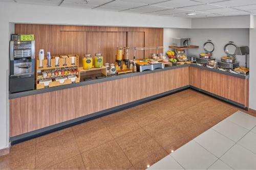 a restaurant with a counter with food on it at City Express by Marriott Puebla Angelopolis in Puebla