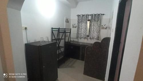 a bathroom with a black vanity and a mirror at God's Gift Morjim in Morjim