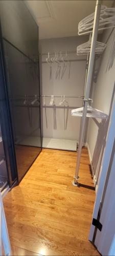 a walk in closet with hangers and a wooden floor at Chambre Royale in Ottawa