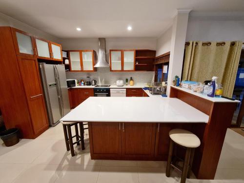 a kitchen with a large white counter top in it at ทิวาพูลวิลล่า หัวหิน Thiva Pool Villa Hua Hin in Hua Hin