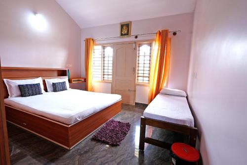 a small bedroom with a bed and a window at Kodebailu Homestay - 3BH Full Villa, Home Food, Coffee Estate in Sakleshpur