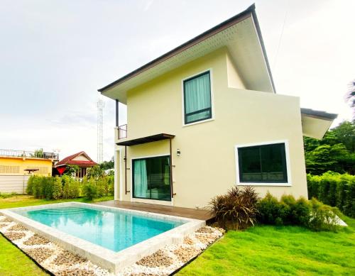 a house with a swimming pool in front of it at Krabi Aonang & Alpha villa in Ao Nam Mao