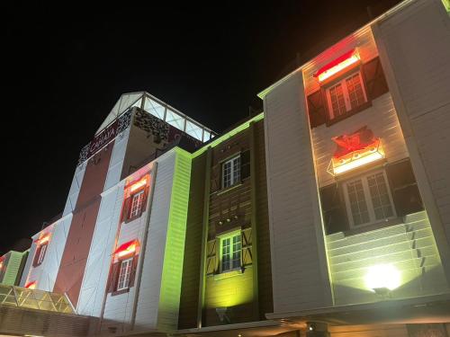 a building with brightly colored windows at night at ホテルチャハヤ in Itako