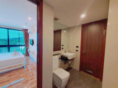 a bathroom with a bed and a toilet and a sink at Doi Sutep Hill in Chiang Mai