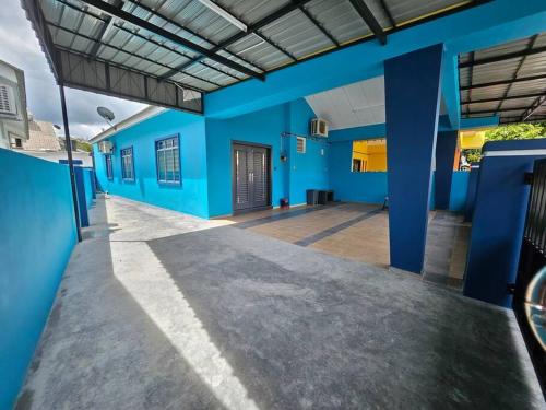 a building with blue walls and a hallway at Mikhael Homestay Near Uitm Segamat in Segamat
