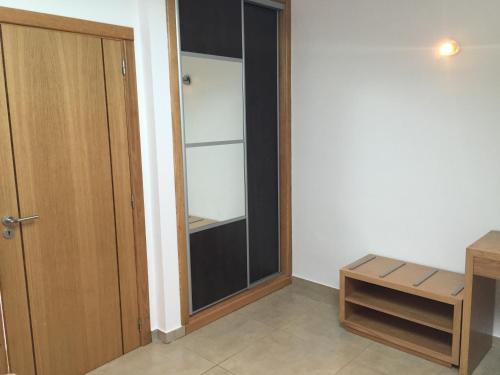 a empty room with a glass door and a bench at Gites Des Sablons in Châtillon-sur-Marne