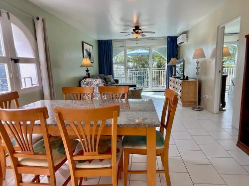 a dining room and living room with a table and chairs at The Frederiksted Hotel in Frederiksted