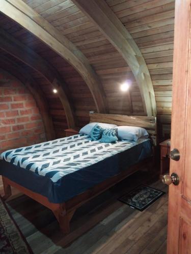 a bedroom with a bed in an attic at Hacienda Aventuras en el Paraíso in Quito