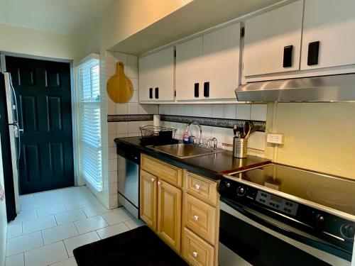 a kitchen with a sink and a stove at The Frederiksted Hotel in Frederiksted