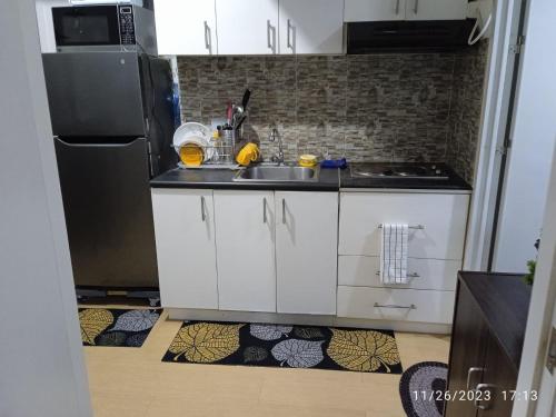 a kitchen with a sink and a refrigerator at 1 BR Centrio Tower 926 in Cagayan de Oro