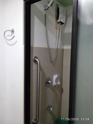 a shower in a bathroom with a shower head at 1 BR Centrio Tower 926 in Cagayan de Oro