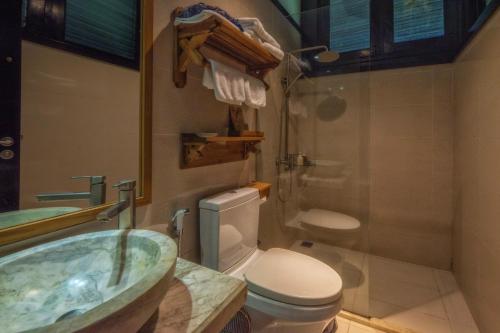 a bathroom with a sink and a toilet and a shower at Sapa Heaven - Sapa Jade Hill in Sa Pa