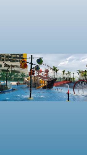 a water park with a slide in the water at SuteraMuslimOnlyHomestay Bali Residence Melaka in Melaka