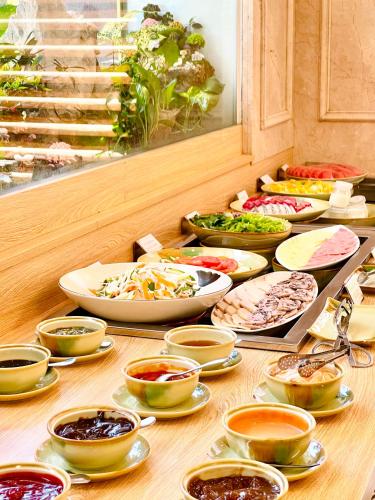 a table with many different bowls and plates of food at Aquasun Hotel Phu Quoc in Phu Quoc