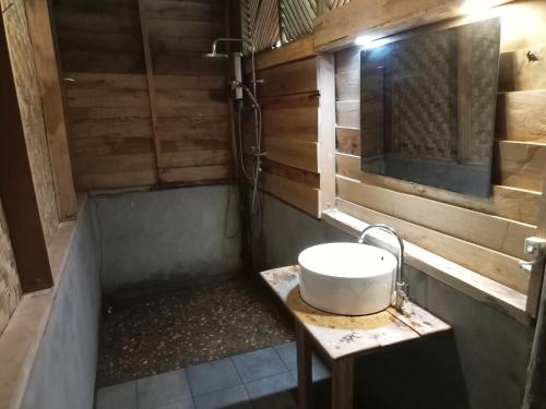 a bathroom with a sink and a tub at Fandee Island - Mountain House - Tad Lo Bolaven Loop Pakse in Ban Kiangtat
