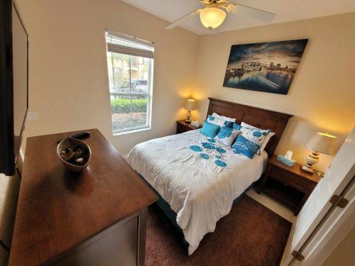 a bedroom with a bed with blue pillows at Townhouse in Regal Palms Resort, Amenities, Pool & lazy river, Near Disney, Orlando in Davenport