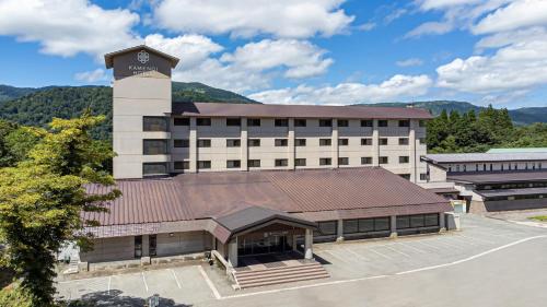 a building with a clock tower on top of it at KAMENOI HOTEL Tazawako in Senboku