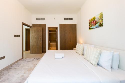 Postel nebo postele na pokoji v ubytování Beautiful contemporary 1BR Apt - Al Barsha South