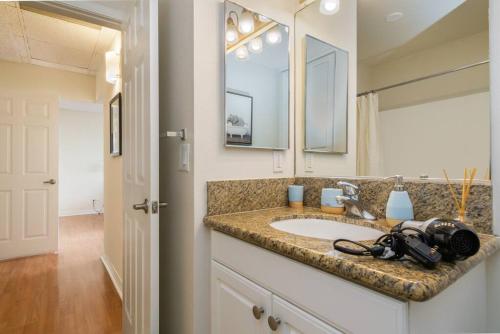 a bathroom with a sink with a camera on it at Panoramic Penthouse Venice/ Marina Del Rey. in Los Angeles