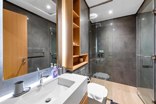 a bathroom with a sink and a shower at Modern Studio APT Sadaf 6, JBR in Dubai