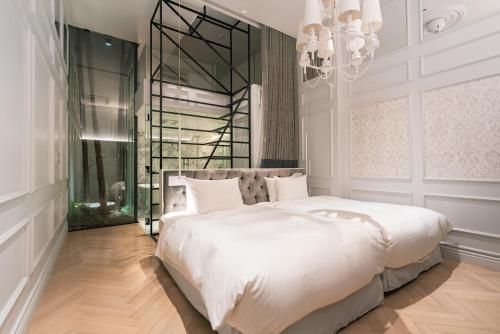 a bedroom with a large white bed and a chandelier at Y11 azabu hotel by Mrt in Tokyo