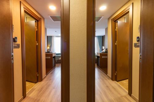 a row of doors in a room with wooden floors at Tilya Resort Hotel in Trabzon