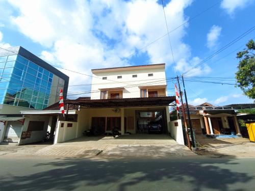 a building in front of a building with a sky at Kresna Guest House Syariah Pacitan in Pacitan