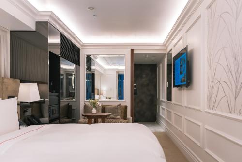 a bedroom with a large bed and a living room at Y11 azabu hotel by Mrt in Tokyo