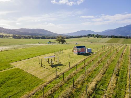 an aerial view of a farm with an rv in a field at Warburton Tiny House - Tiny Stays in Yarra Junction