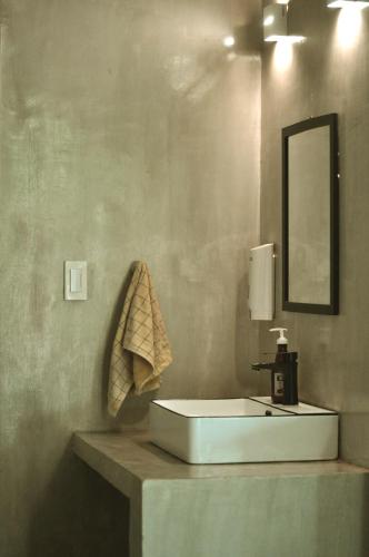 a bathroom with a white sink and a mirror at Beach People Hostel Bantayan Island in Ocoy