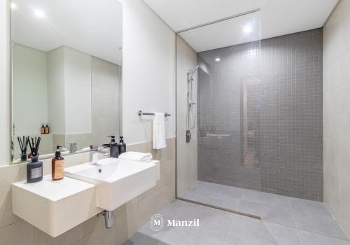 a bathroom with a sink and a shower at Manzil - 2BR Apt in Al Wasl Residences with Park View, Dubai Trade Center in Dubai