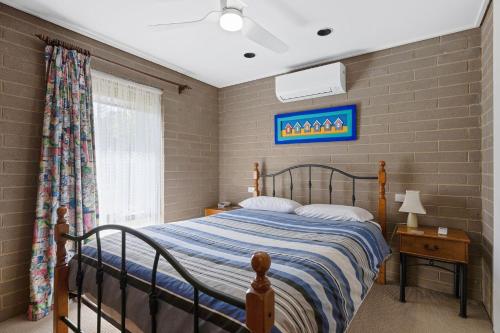 a bedroom with a bed with a blue comforter at 21 Shamrock Avenue Cowes in Cowes