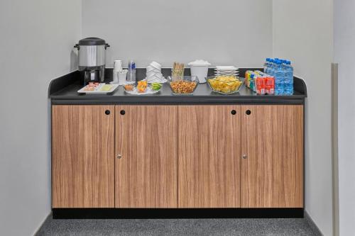 a counter with bowls of food on top of it at City Express by Marriott Monterrey Aeropuerto in Monterrey