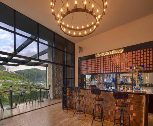 a bar in a restaurant with a view at The Golden Ridge Hotel in Nuwara Eliya