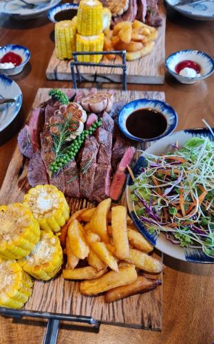 a table topped with different types of food on plates at TỊNH Retreat Phu Quoc in Phu Quoc