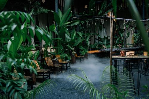 a room filled with lots of green plants at TỊNH Retreat Phu Quoc in Phu Quoc
