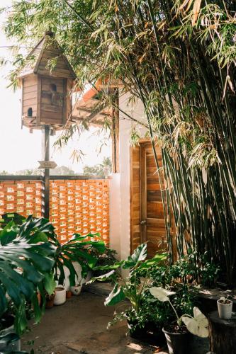 a bird house and plants in a garden at TỊNH Retreat Phu Quoc in Phu Quoc