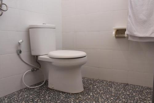 a bathroom with a white toilet in a room at Guest House 88 Pandawa in Nusa Dua
