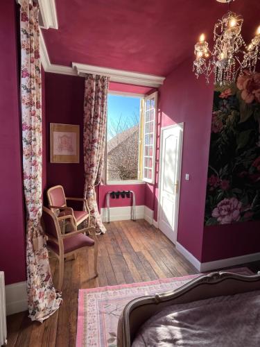 ein Schlafzimmer mit lila Wänden und einem Fenster in der Unterkunft Maison de Mags & Mags Marie Antoinette Room in Lanouaille