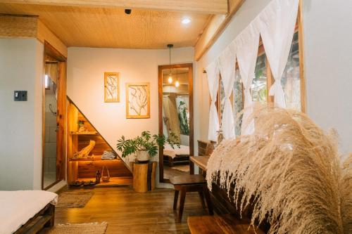 a living room with a couch and a staircase at TỊNH Retreat Phu Quoc in Phu Quoc