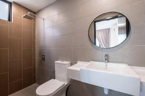 a bathroom with a sink and a toilet and a mirror at Blissful Cottage@FeelHome/2BR,7pax,MRT 中文房东 in Kuala Lumpur