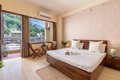 a bedroom with a large bed and a balcony at Homlee - Hill View Apartment Luxury in Rishīkesh