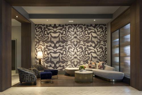 a living room with a couch and a patterned wall at Le Méridien New Orleans in New Orleans