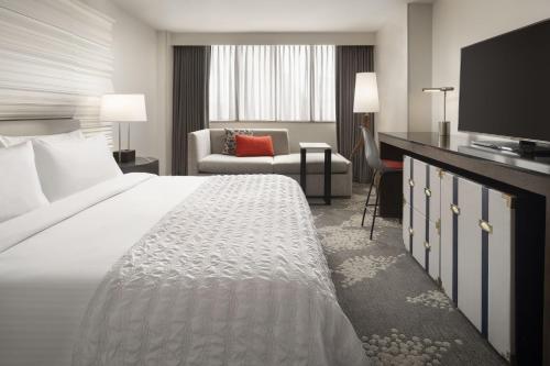 a hotel room with a bed and a television at Le Meridien New Orleans in New Orleans