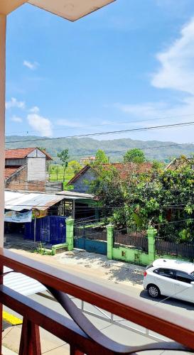 a view from a balcony with a car on a street at Kresna Guest House Syariah Pacitan in Pacitan