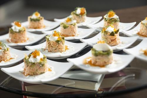 a bunch of food on plates on a glass table at Le Meridien New Orleans in New Orleans