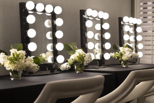 a room with a table with chairs and a mirror at Le Meridien New Orleans in New Orleans